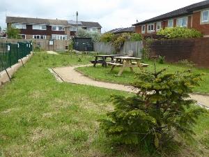 Garden site with picnic benches and gravel path