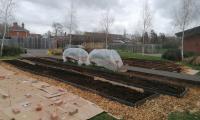 photo of garden showing long raised growing beds filled with compost