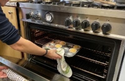 kitchen facilities - muffin tray being removed from a oven