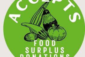 round green badge with picture of vegetables 'Accepts food surplus donations'